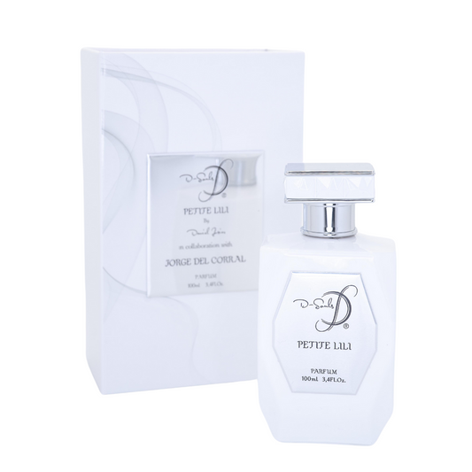 La imagen muestra un set de perfume compuesto por un frasco y su estuche. El frasco, de líneas geométricas definidas y acabado impecable, presenta una tonalidad blanca brillante. En su cara frontal destaca una placa metálica en tono plateado, donde se lee el nombre de la fragancia “Petite Luli”, junto con el volumen (100 mL / 3.4 FL. OZ.) y la indicación de ser un parfum. La marca “D-Souls” aparece elegantemente grabada en la placa, vinculando el producto con su origen de autor y la firma creativa de Daniel