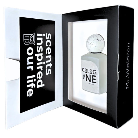 Estuche del perfume "The Cologne" de Mr. Waldron, con caja negra y blanca que muestra el frasco blanco con tapón moteado. Lema “Scents inspired our life”. Disponible en Perfumería Sanchotena.