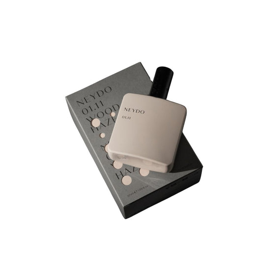 Perfume Neydo 01.11 en frasco beige con caja, fragancia Wood Haze cálida y amaderada.