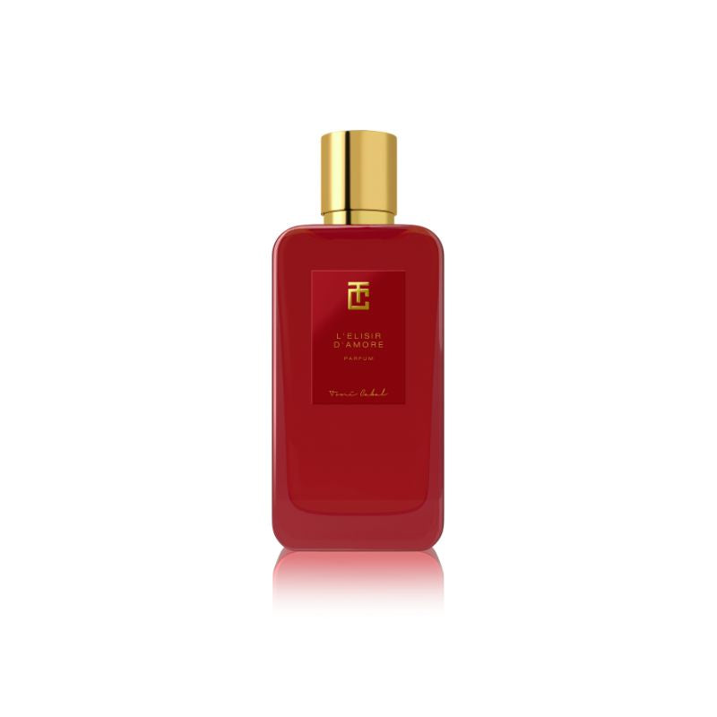 Botella de ‘L’Elisir d’Amore Parfum’ de Toni Cabal en color rojo con tapón dorado, evocando un aroma romántico y seductor