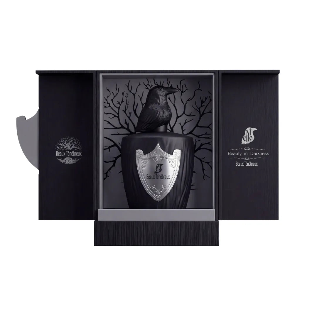 Estuche abierto de Beaux Ténébreux, El Nicho, con el frasco de tapón de cuervo sobre fondo gris con árbol y la frase Beauty in Darkness