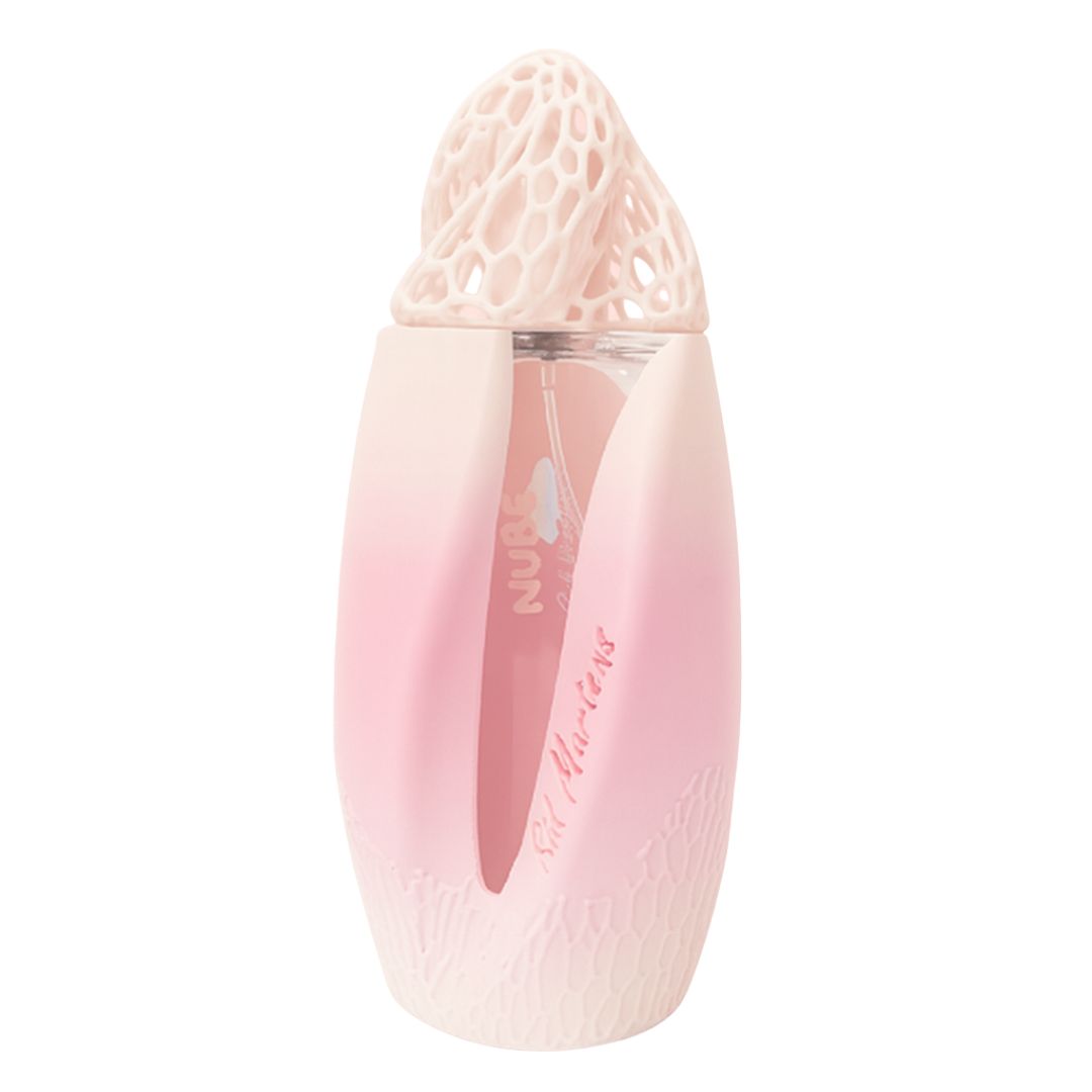 Frasco de Nube, Sid Martens, perfume floral amaderado, aroma suave en tono rosa degradado